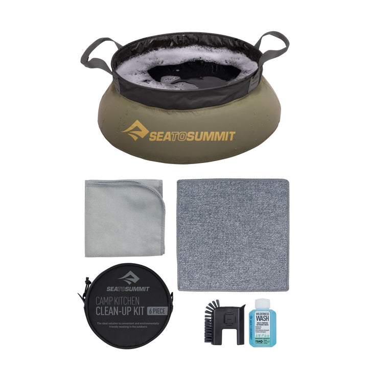 Fabric sink of soapy water, mini scrubbing brush, and other items on a white background
