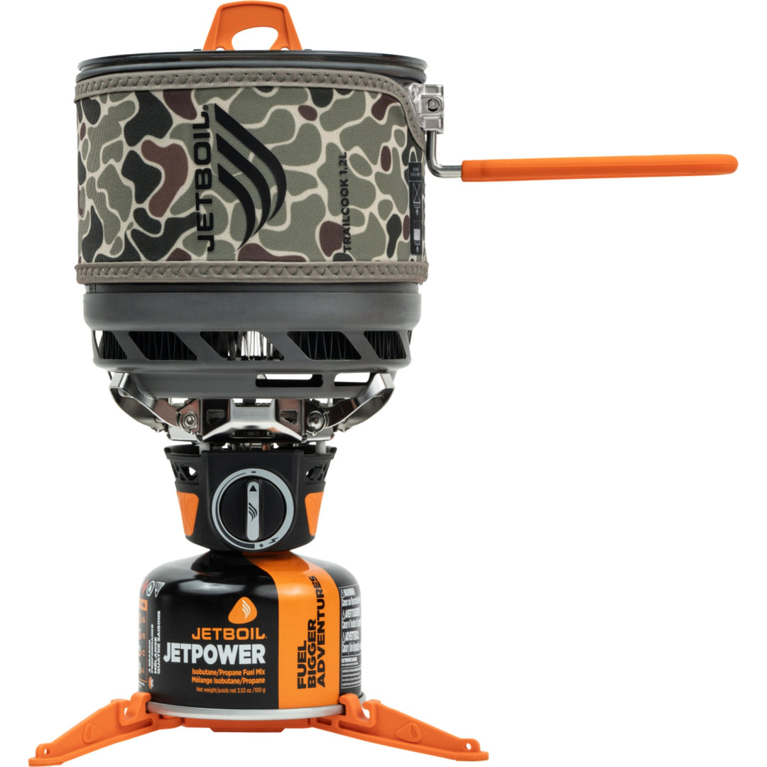 Camouflage camping stove cosy with orange accents on a white background