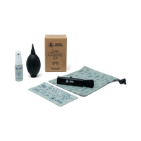 Nocs lens cleaning kit with spray bottle, blower, brush, and cloth on a white background