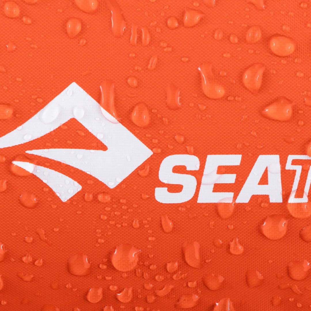 Orange surface with water droplets and a white logo on an orange background