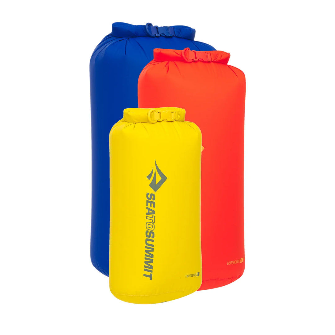 Three dry bags in blue, yellow, and red with Sea to Summit logo on a white background