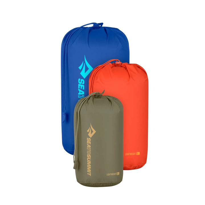 Three compression bags in blue, green, and red with Sea to Summit logo on a white background
