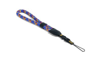 Colorful rope camera strap with a black clip on a white background