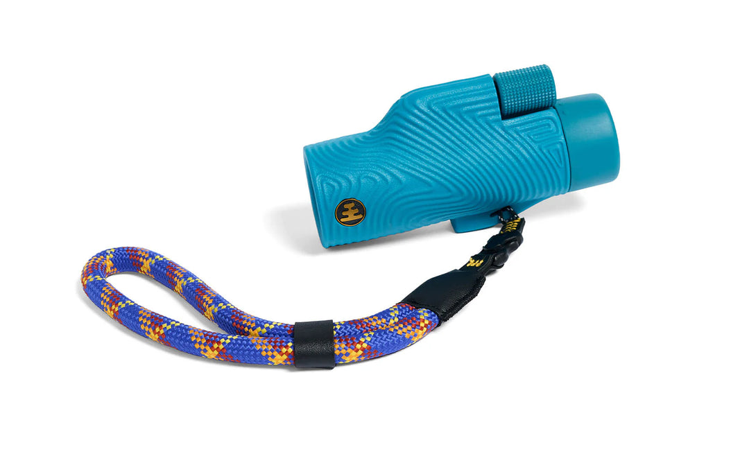 Blue monocular with colorful strap on a white background