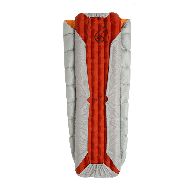 Grey sleeping bag on red inflatable mat on a white background.