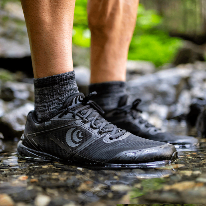 Person wearing Topo Terraventure 4WPs standing in a shallow stream