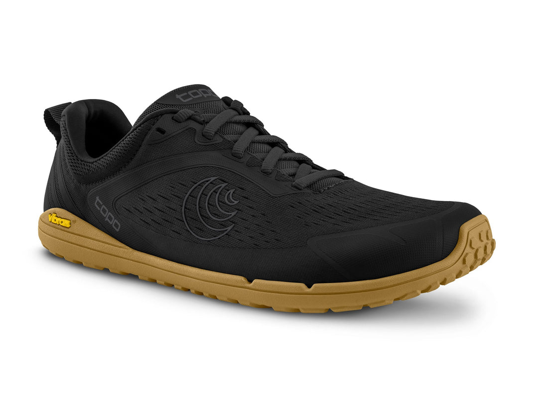 Black athletic shoe with brown sole on a white background
