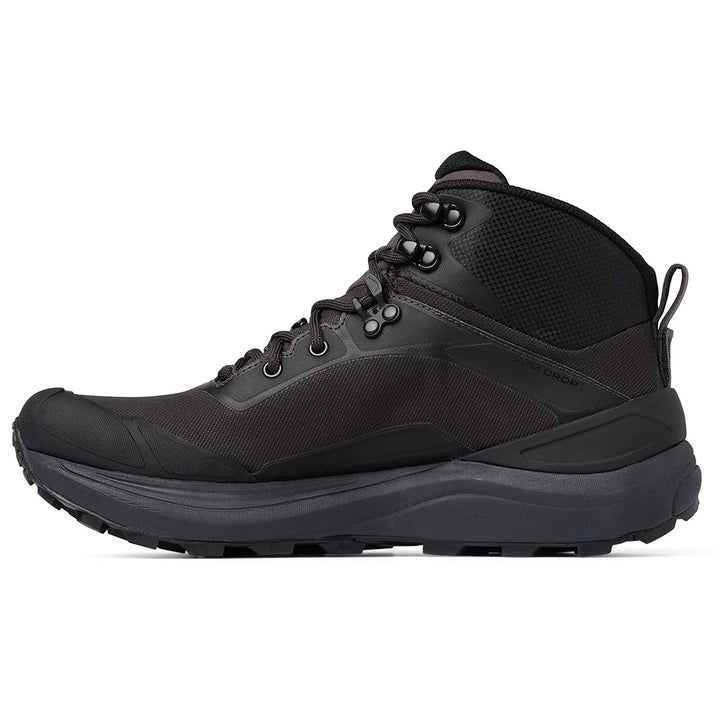 A mid-cut hiking boot from Topo shown in a side profile view against a solid white background. The boot features a black mesh upper with brown synthetic overlays, a black and brown midsole, and a rugged brown and black outsole.