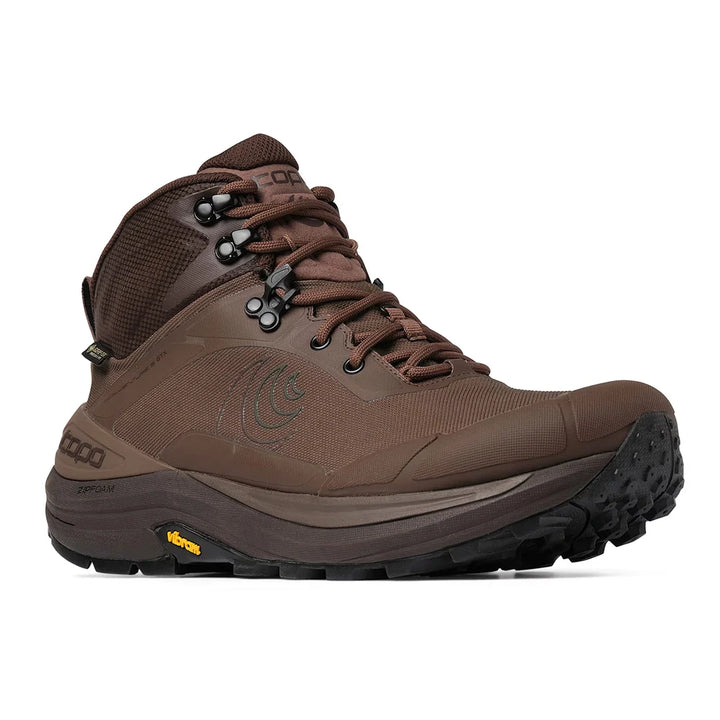 A brown mid-cut outdoor hiking boot with a black and brown Vibram sole, shown from a side profile on a white background.
