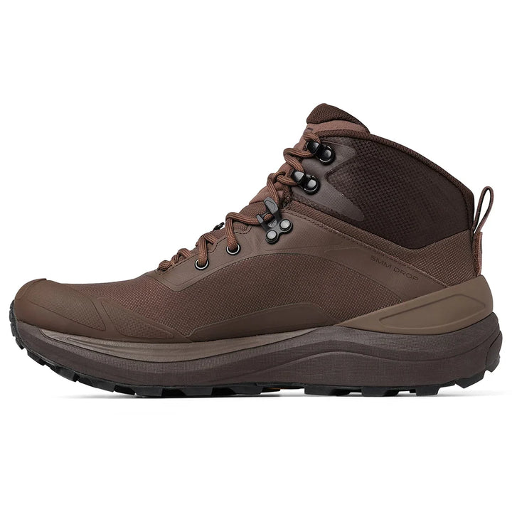 A brown mid-cut hiking boot with a thick brown and black sole, shown in a side profile view against a plain white background.