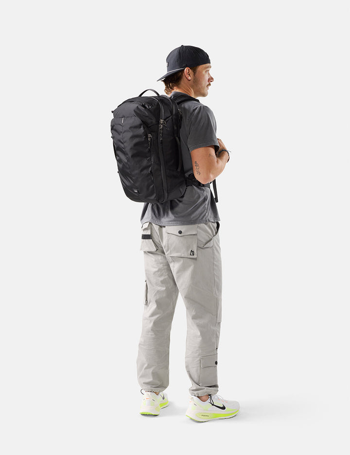 Matador 30L Carry-On Travel Pack - Black, worn on the back, side view