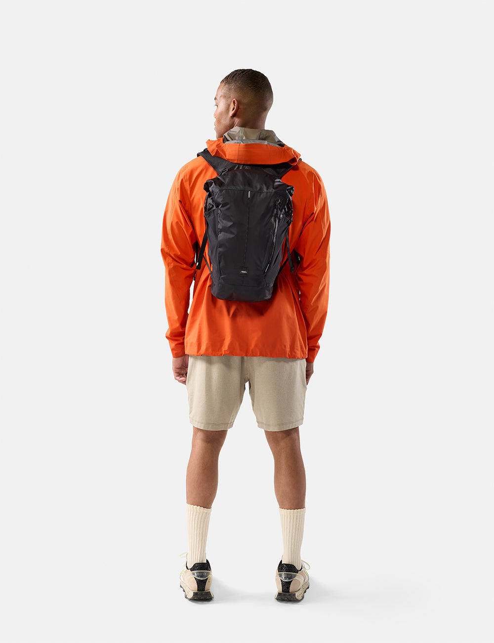 Matador 18L Waterproof Packable Backpack - Packed - Black, worn on the back while hiking