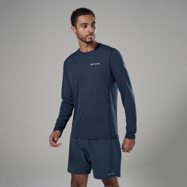 Man wearing navy athletic outfit with Montane logo on a grey background