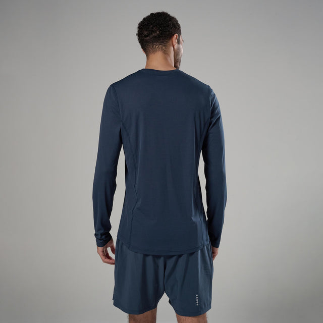 Person wearing a navy long-sleeve athletic shirt and shorts on a gray background