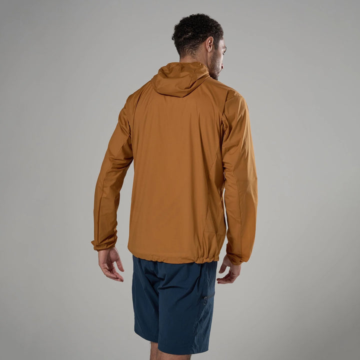 Man wearing a brown jacket and blue shorts on a gray background