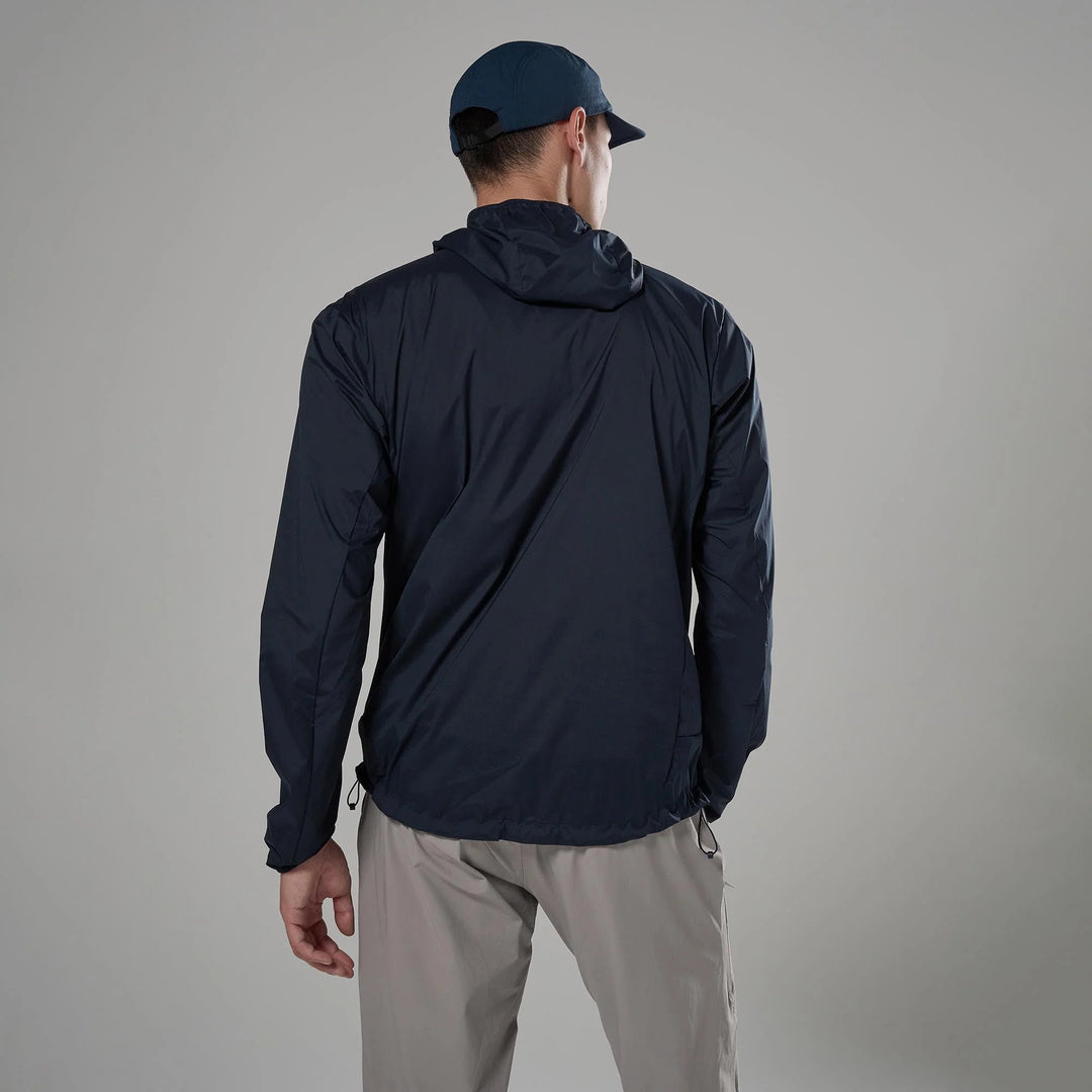 Person wearing a navy jacket and cap on a gray background