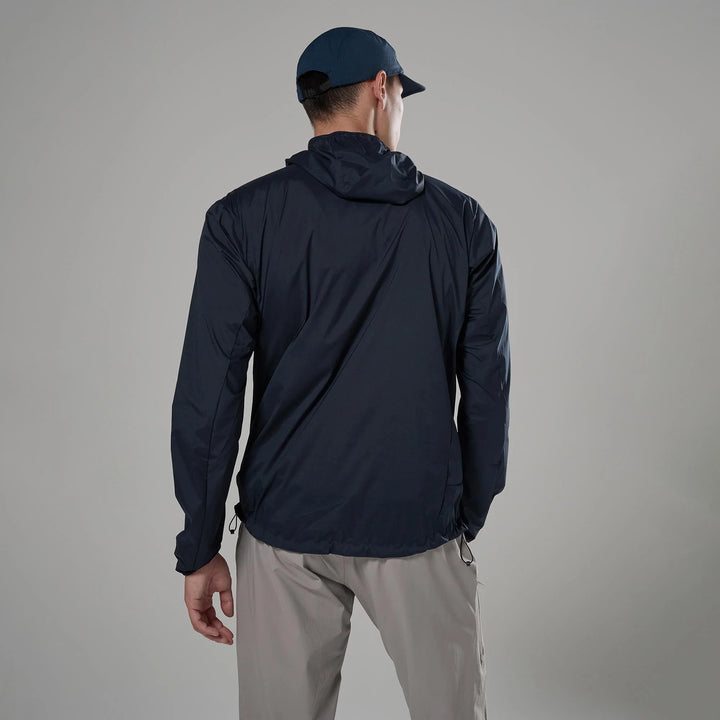 Person wearing a navy jacket and cap on a gray background