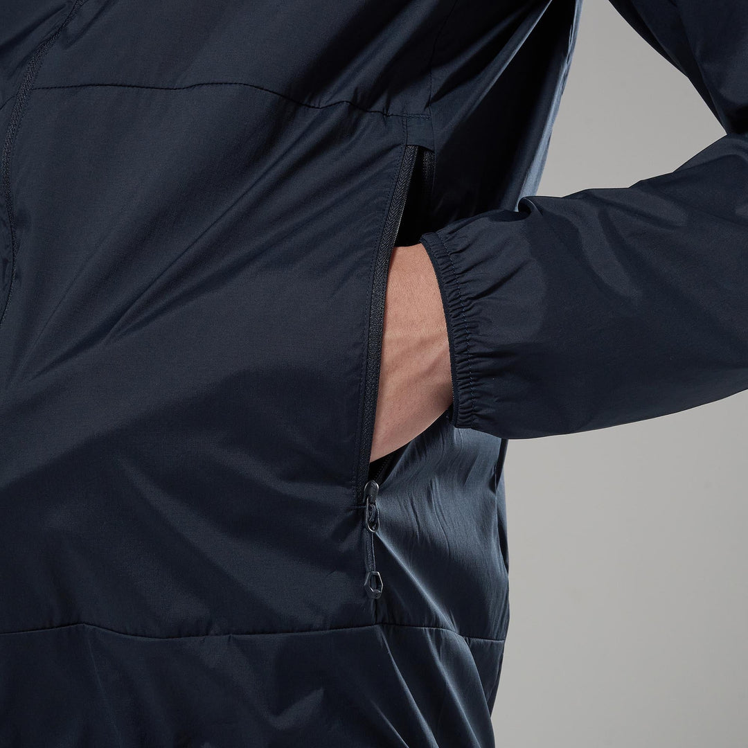Person wearing a dark blue jacket with a gray background