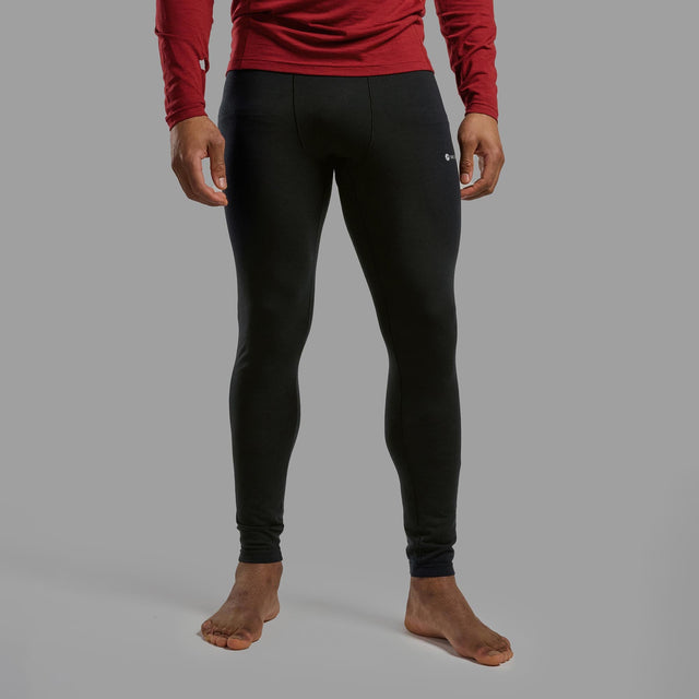 Person wearing black leggings and a red long-sleeve shirt on a gray background