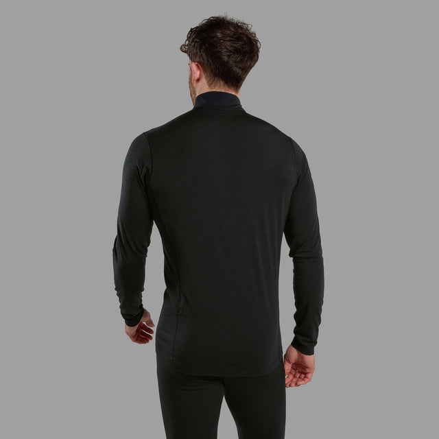 Man wearing a black long-sleeve shirt against a grey background
