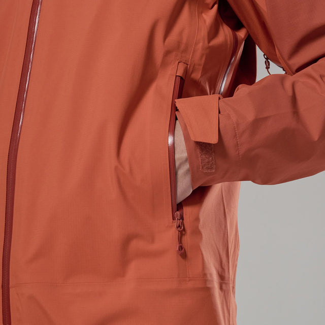 Close-up of the pocket of an orange rain jacket with a zipper