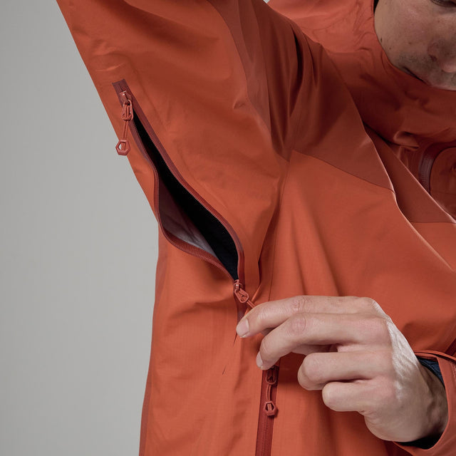 Close up of the armpit zip on an orange rain jacket