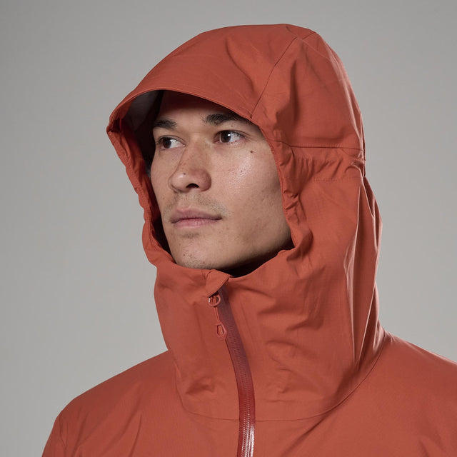 Person wearing a orange hooded jacket against a white background