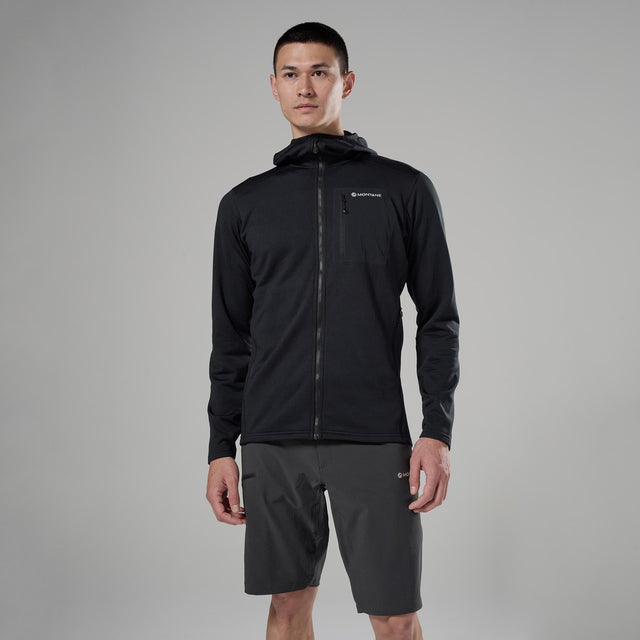 Man wearing a black jacket and grey shorts on a grey background