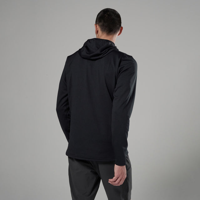 Person wearing a black jacket and pants on a grey background