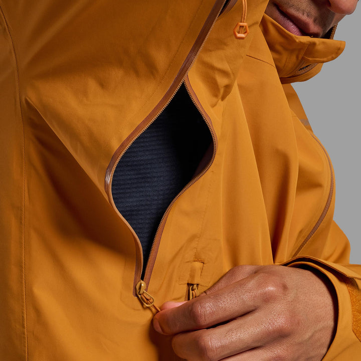Close up of the under arm of someone wearing a raincoat showing a "pit zip"