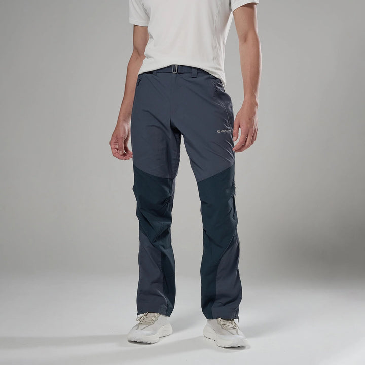 Person wearing dark gray pants on a plain background