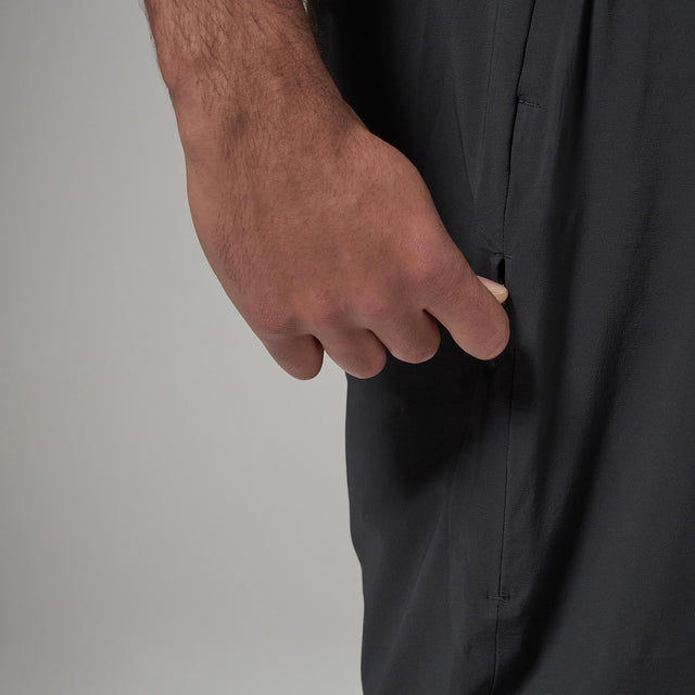 Close-up of side zip of black pants with a neutral background