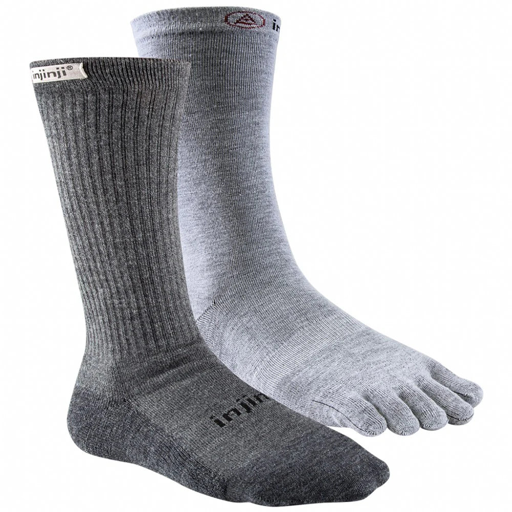 A grey sock next to a white five-toe sock on a white back ground