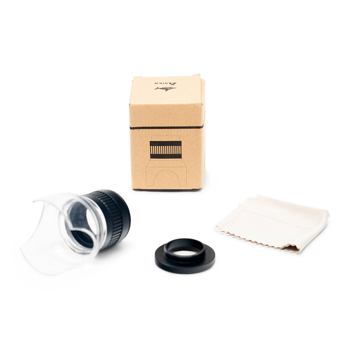 Scope lens, cleaning cloth, and box on a white background