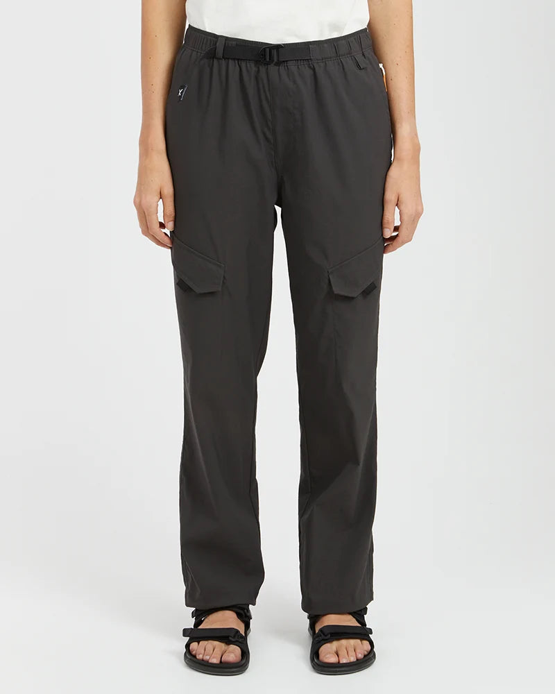 Person wearing black cargo pants on a white background