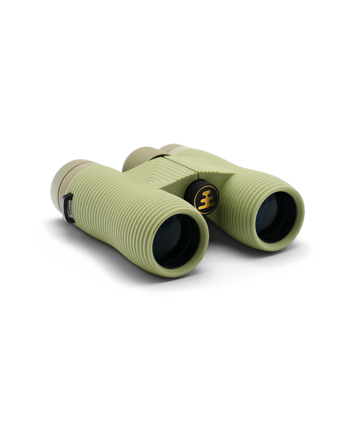 Compact green binoculars with Nocs Provisions logo on a white background