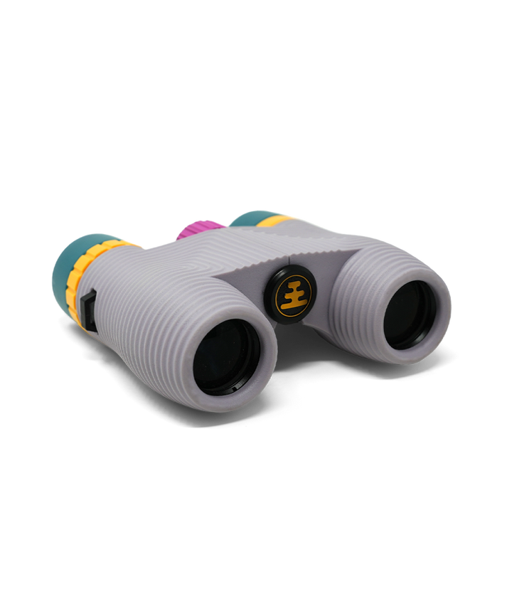 Compact lavender binoculars with colourful highlights on a white background