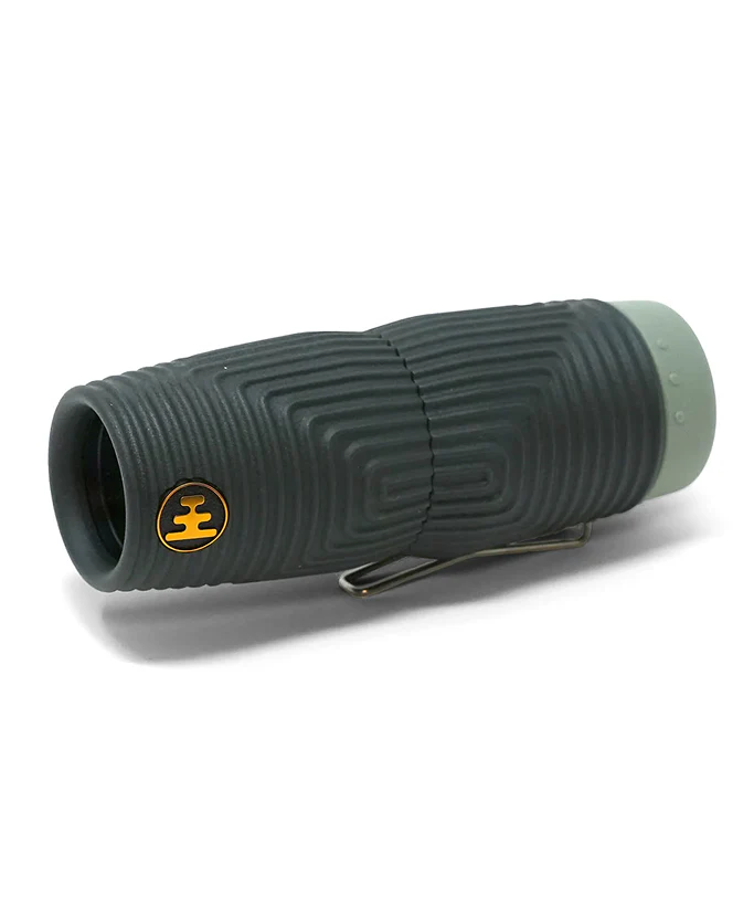 A dark green textured monocular with a gold logo on the side and a light green end cap, resting on a white background.