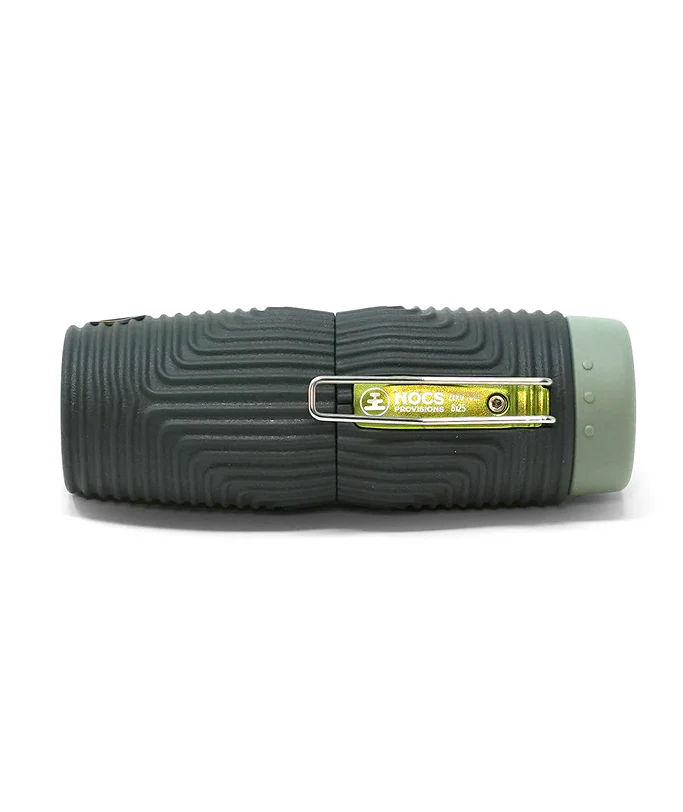 A black textured monocular with a green end cap and a silver metal clip over a yellow Nocs brand logo, shown on a white background.