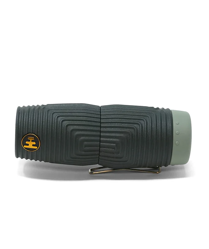 A black textured monocular with a green end cap and a silver metal clip over a yellow Nocs brand logo, shown on a white background.