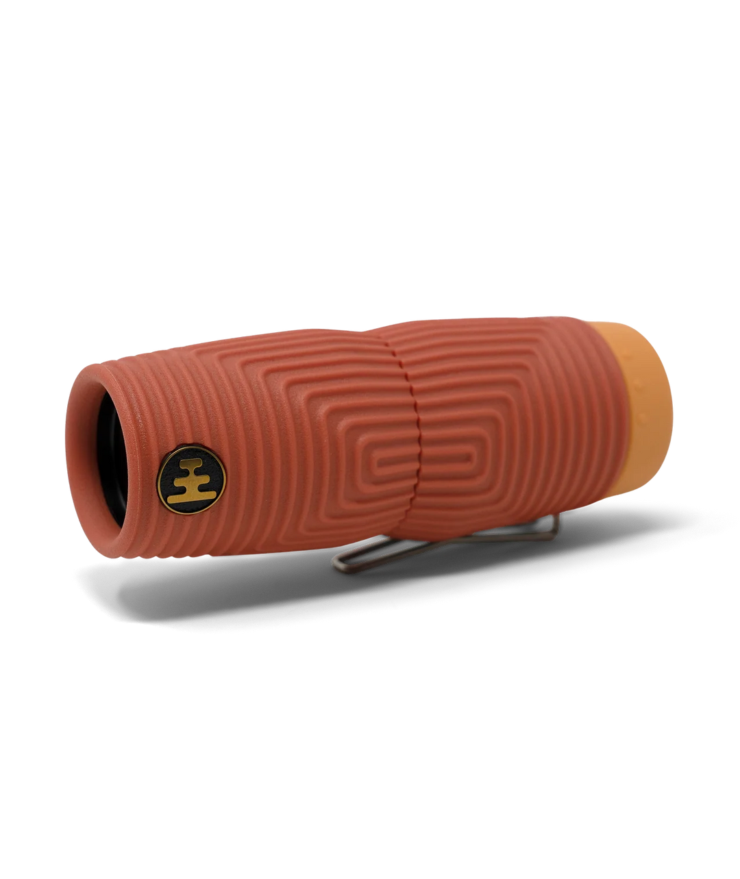 A terracotta coloured textured monocular with a light orange end cap and a silver metal clip and a black Nocs brand logo, shown on a white background.