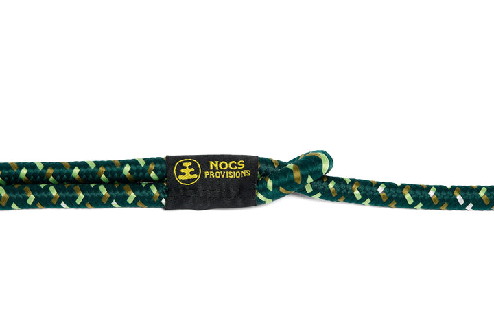 A close-up of a braided rope with a black woven label that reads &