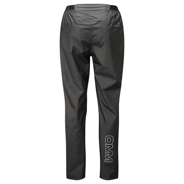 Black waterproof pants with an elastic waistband viewed from behind. OMM logo on back of left calf.