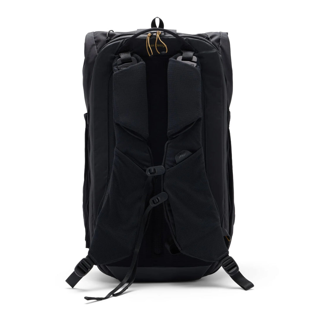 Black backpack shown from the back, featuring padded shoulder straps, compression buckles, and a top zipper closure, photographed on a clean white background.