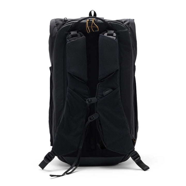 Black backpack shown from the back, featuring padded shoulder straps, compression buckles, and a top zipper closure, photographed on a clean white background.