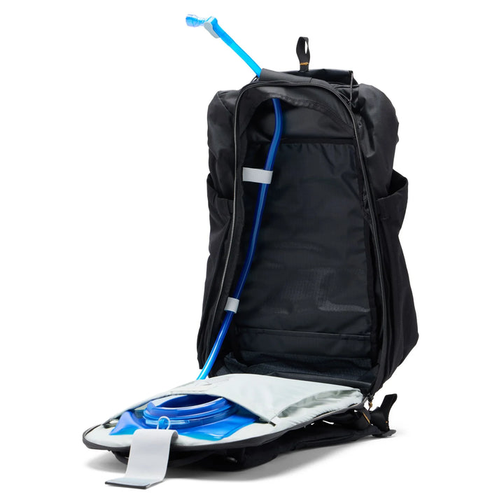 Black backpack with blue and white water bladder on a white background