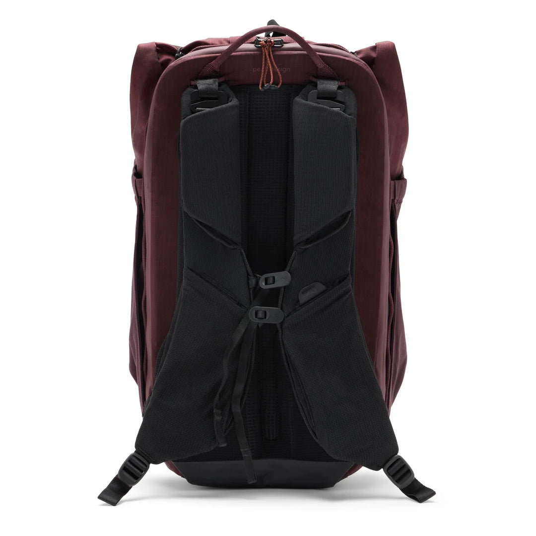 Back view of a maroon backpack with black interior on a white background