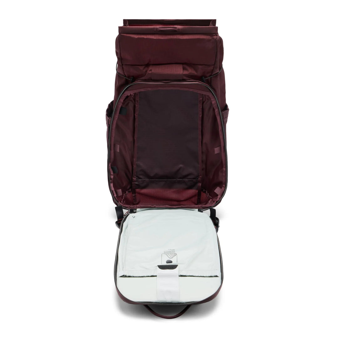 A dark burgundy backpack shown from a top-down view with its main compartment and a light gray insulated insert both open, set against a plain white background.