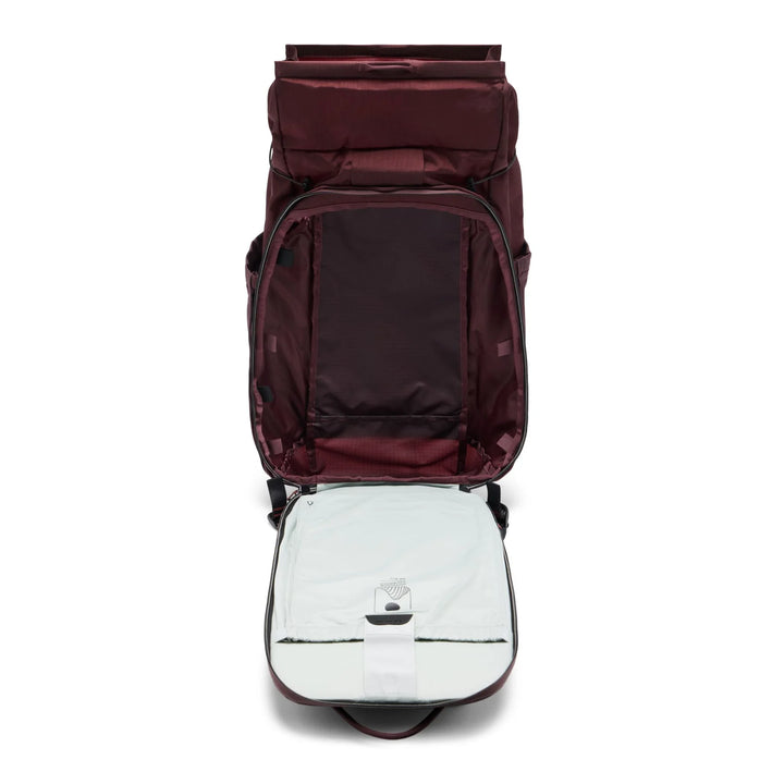 A dark burgundy backpack shown from a top-down view with its main compartment and a light gray insulated insert both open, set against a plain white background.
