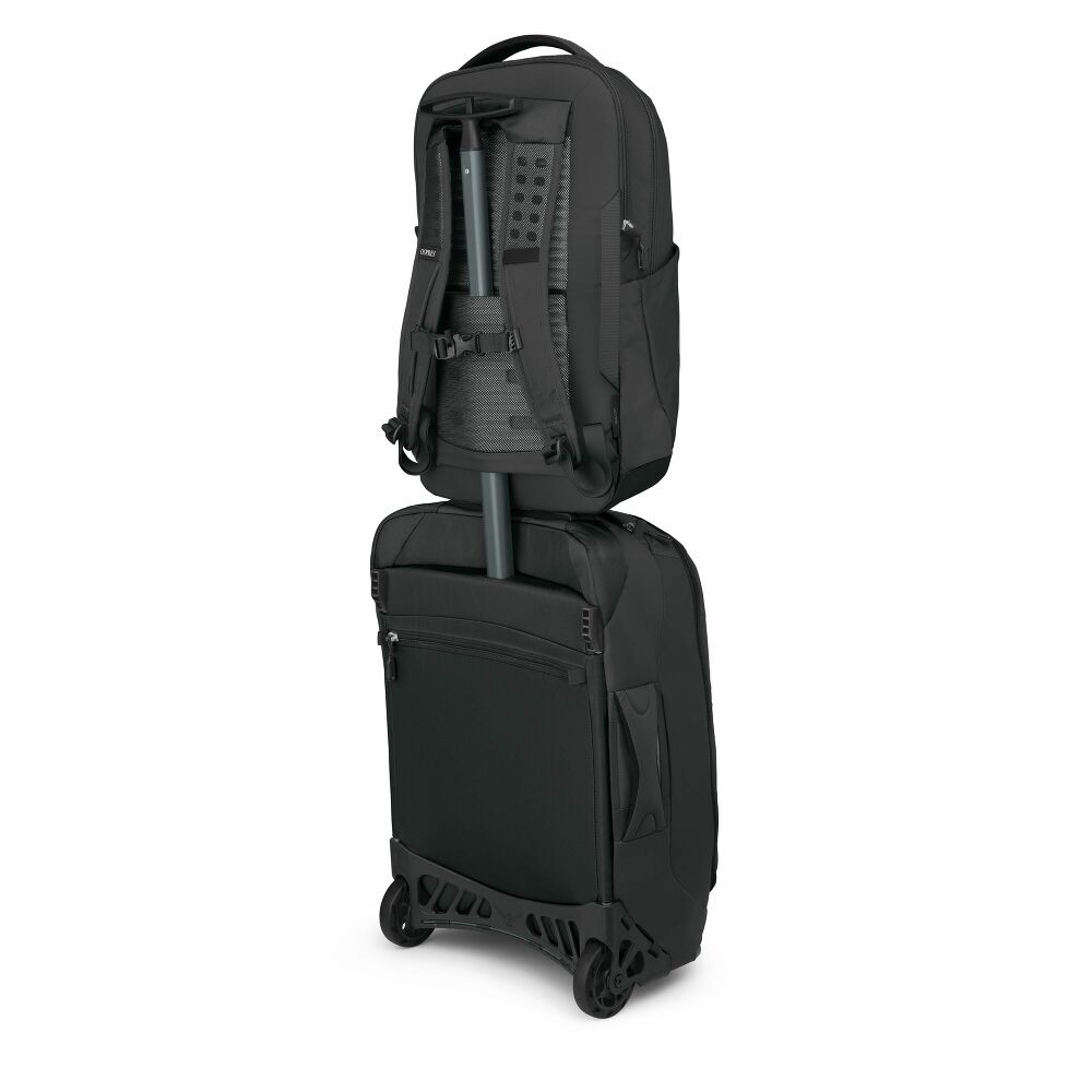 Black backpack and suitcase stacked on a white background